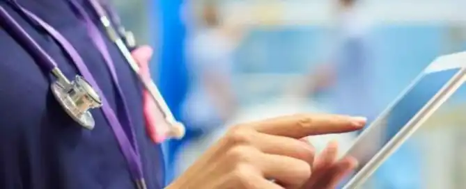 A doctor or nurse on an iPad