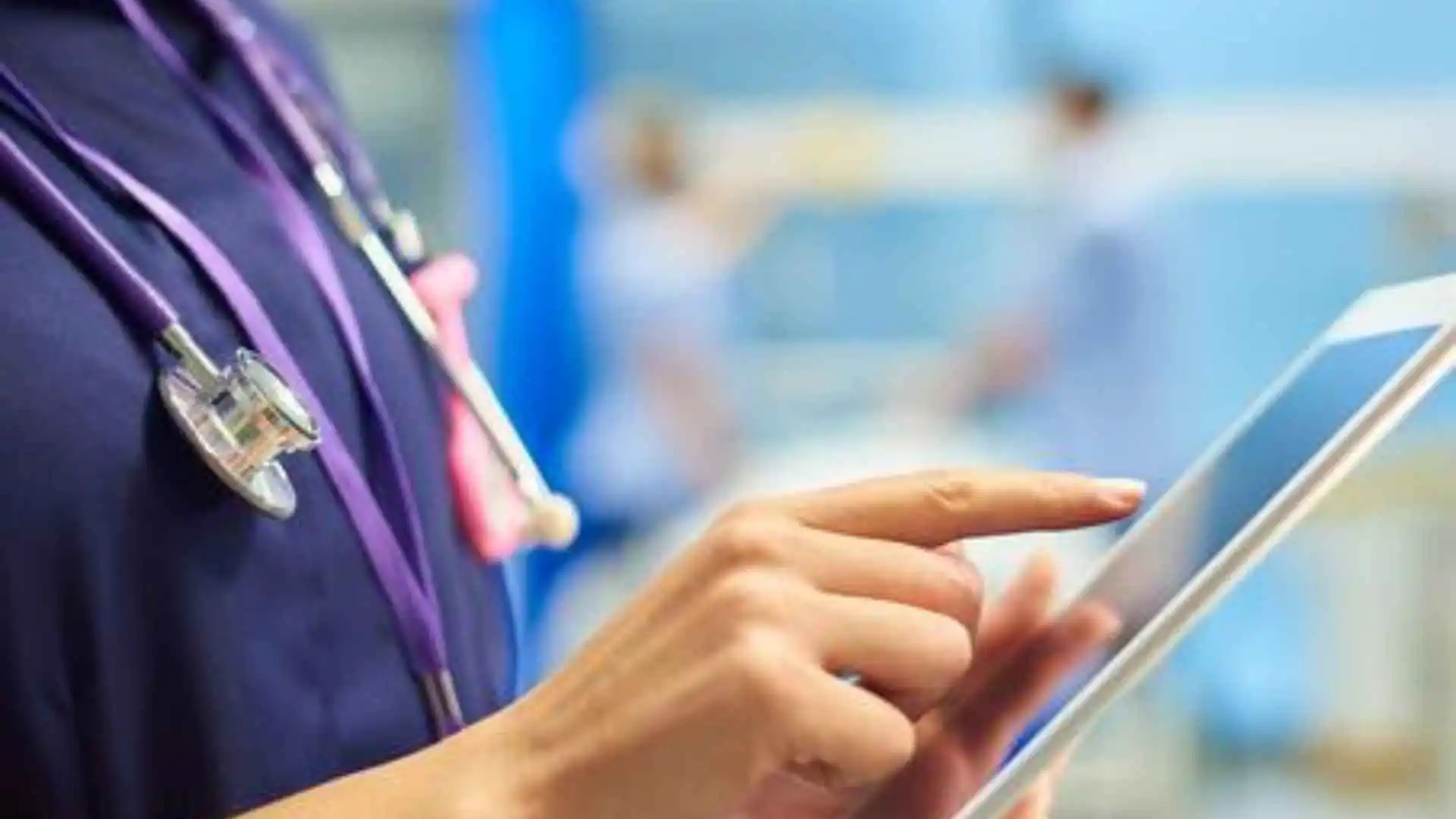 A doctor or nurse on an iPad