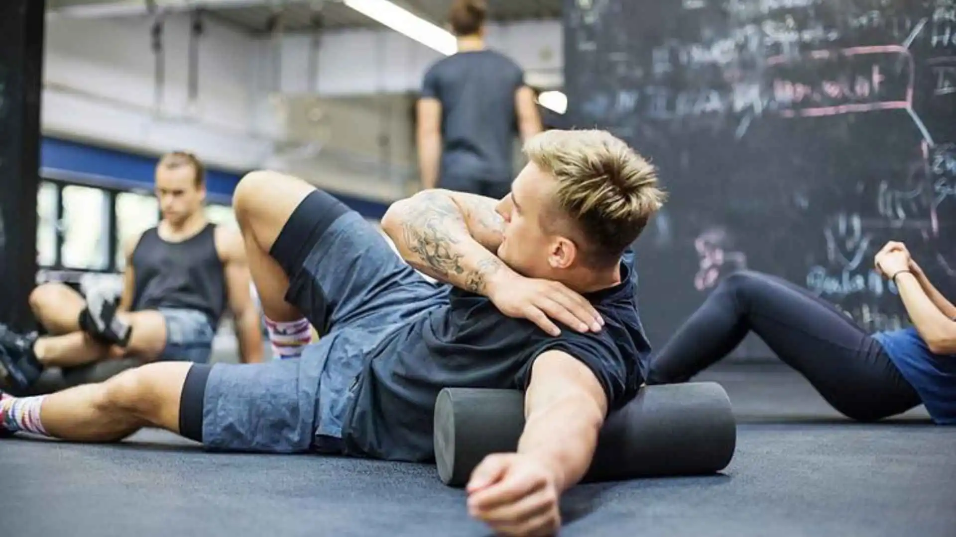 A man using a foam roller to stretch