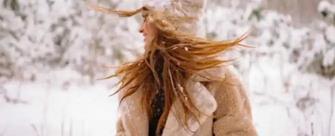 A woman outside in the snow in winter
